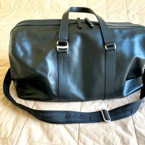 Authentic Salvatore Ferragamo black genuine leather travel bag silver hardware